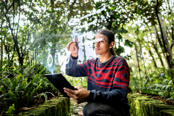young-man-using-augmented-reality-device-at-nature-park-stock-photo.jpg