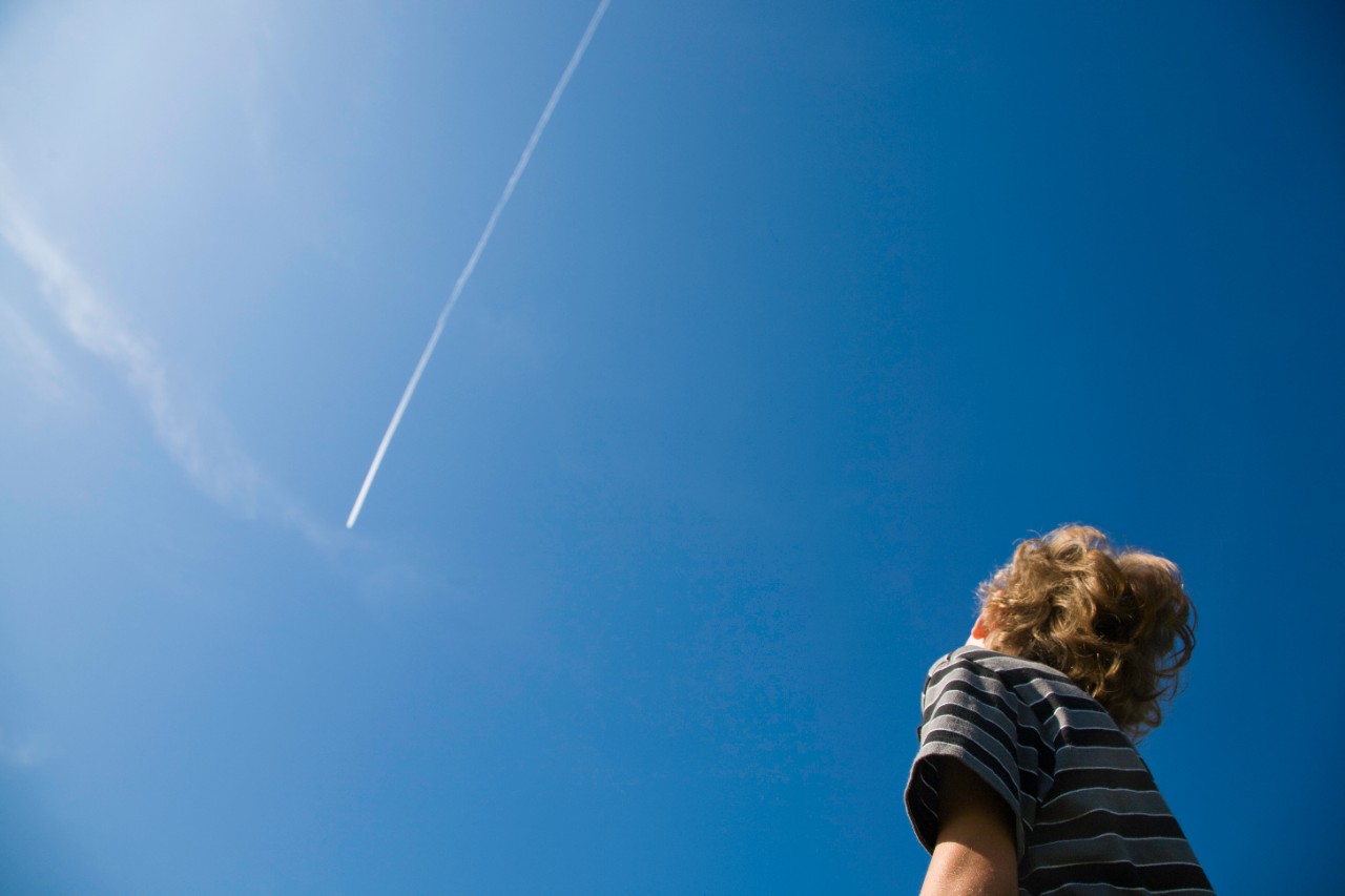 boy-looking-at-jet-contrail-173042660.jpg