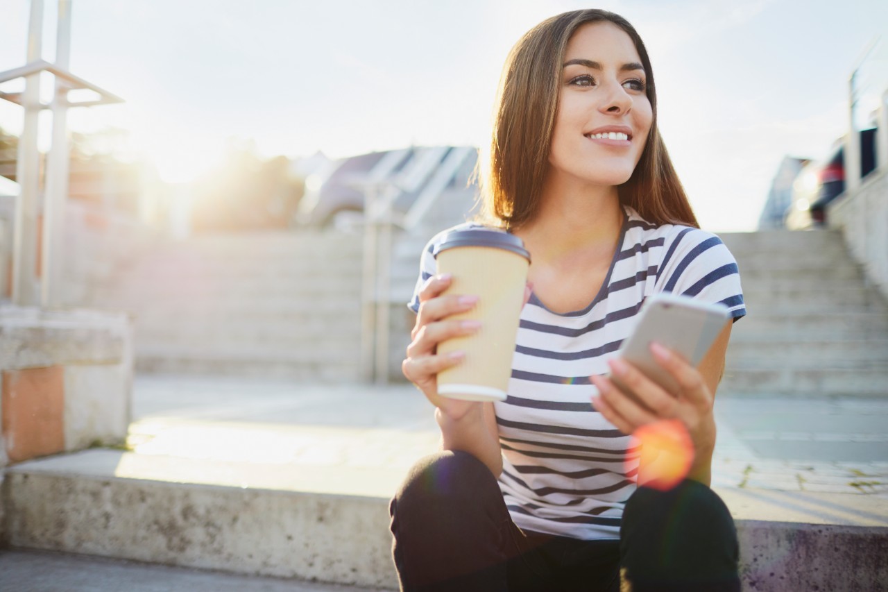 woman-holding-mobile-coffee-getty-900243836.jpg