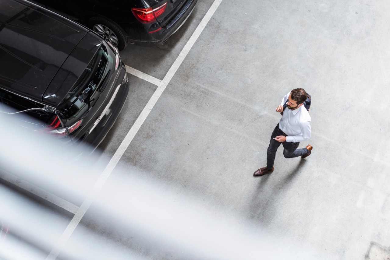 businessman-backpack-running-to-car-getty-970176622.jpg